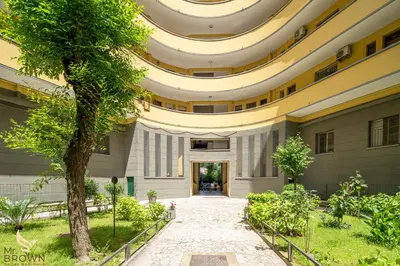 a large building with trees in front of it at Mr Brown - Monteverde House in Rome