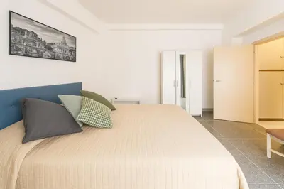 a bedroom with a large bed with pillows on it at Massi Vatican House in Rome