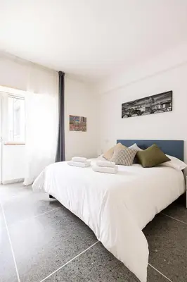 a white bedroom with a large white bed at Massi Vatican House in Rome