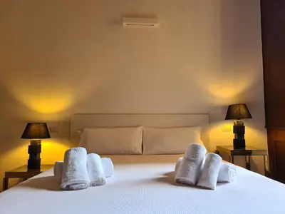 a book sitting on top of a wooden table with a chair at Nox Romana Apartments - Vatican - Threeroom Apt with 2 Bathroom in Rome