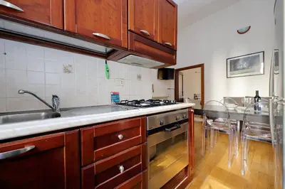 a kitchen with a sink and a stove top oven at Vatican Spacious Modì Apartment in Rome
