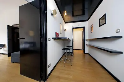 a hallway with a staircase and a room with a stool at 4BNB - Spacious Porta Pia Apartment in Rome