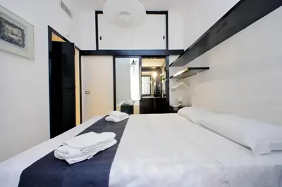 a bedroom with a bed with two white towels on it at 4BNB - Spacious Porta Pia Apartment in Rome