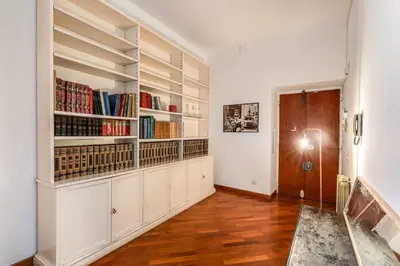 a room with white cabinets and bookshelves at Splendid flat on the Tiber river in Rome