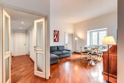 a living room with a couch and a table at Splendid flat on the Tiber river in Rome
