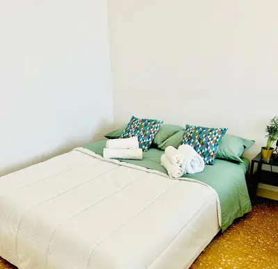 a bed with towels on it in a room at PLANT HOUSE Roma San Paolo in Rome