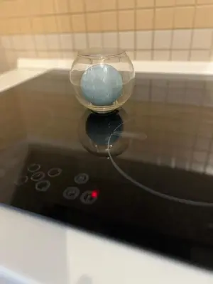 a glass bowl sitting on top of a remote control at Mary's house in Rome