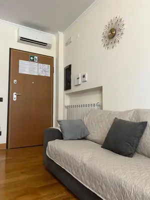 a living room with a couch and a brown door at Mary's house in Rome