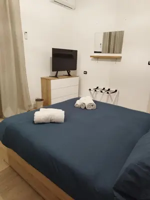 a bedroom with a bed with towels on it at Appartamento Elena & Chiara in Rome