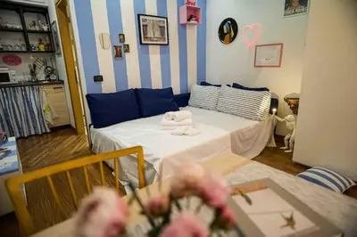 a room with a bed and a table with flowers at Anna’s Crazy Place in Rome