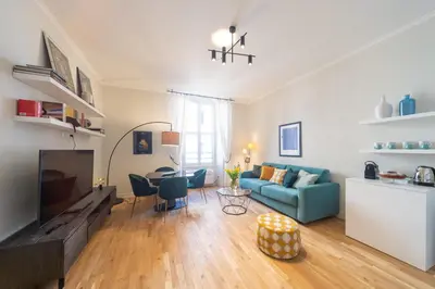 a living room with a blue couch and a table at Casa Cattaneo, a due passi da Santa Maria Maggiore in Rome