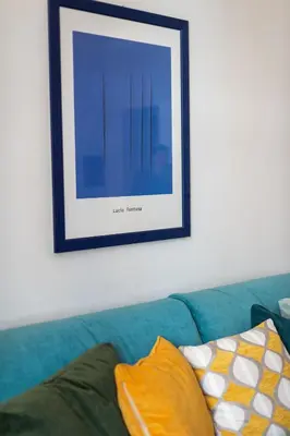 a picture hanging on a wall above a couch at Casa Cattaneo, a due passi da Santa Maria Maggiore in Rome