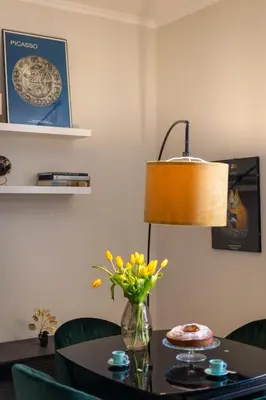 a table with a lamp and a vase with flowers on it at Casa Cattaneo, a due passi da Santa Maria Maggiore in Rome