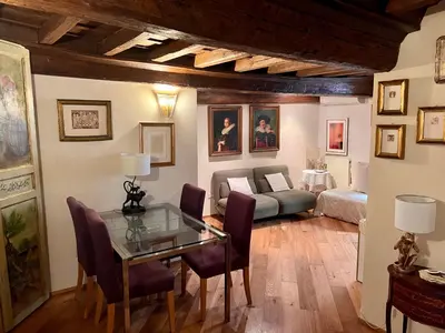 a living room with a table and a couch at Torre della Scimmia apartment in Rome