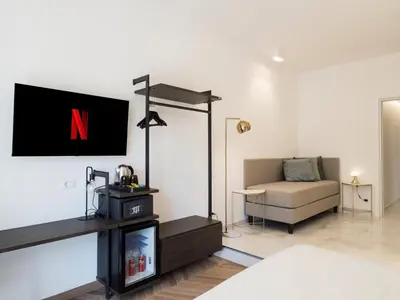 a living room with a tv and a couch at Savoia Rooms Roma in Rome