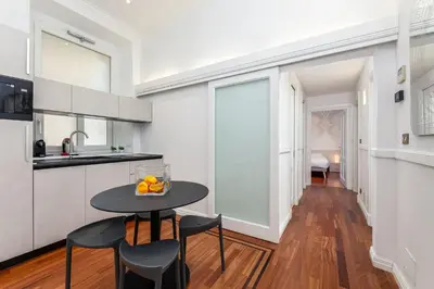 a kitchen with a table and chairs in a room at Aletheia Èlite - Elegant 2 BR in Rome