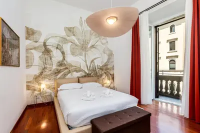 a bedroom with a bed and a wall with a mural at Aletheia Èlite - Elegant 2 BR in Rome