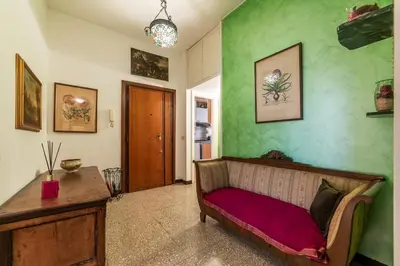 a living room with a couch and green walls at GuestHost - San Giovanni in Laterano Comfy Apartment in Rome