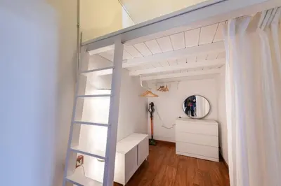a loft bed with a ladder in a room at La Pietra al Pigneto in Rome