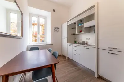 a kitchen with a table and chairs in a room at Casa Marin - Metro Malatesta in Rome