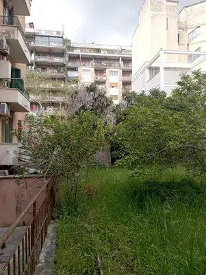 a grassy area in front of a building at Pigneto House in Rome