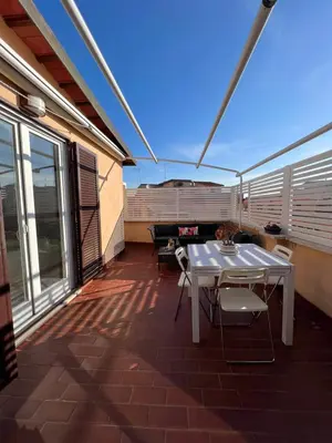 a patio with a table and chairs and a piano at BUBUS Terrace in Rome