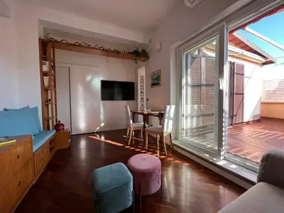 a living room with a table and a large window at BUBUS Terrace in Rome