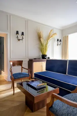 a living room with a blue couch and a table at Casa Violante Luxury Apartment in Rome
