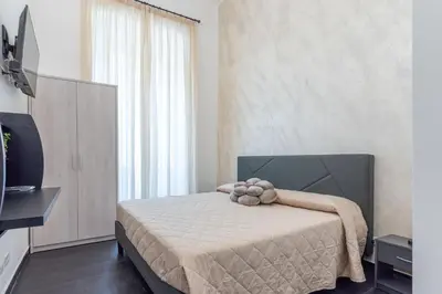 a bedroom with a bed and a large window at Velvet Rooms in Rome