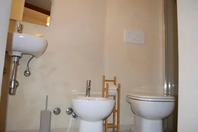 a bathroom with a toilet and a sink at AmareRomaRooms in Rome