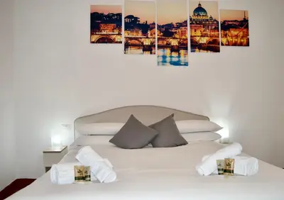 a bedroom with a white bed with a city skyline at AmareRomaRooms in Rome