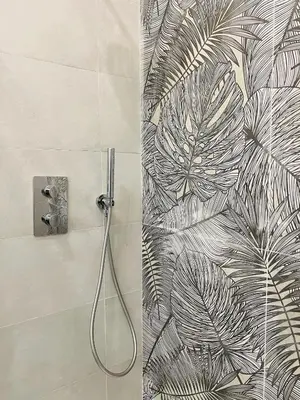 a bathroom with a shower with a leaf wallpaper at New Prati Luxury Apartment in Rome