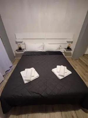 a large bed with two white towels on it at Style House 74 in Rome
