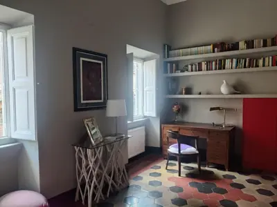 a room with a desk and a chair and a table and window at Warm Charming Apartment in Campo de Fiori in Rome