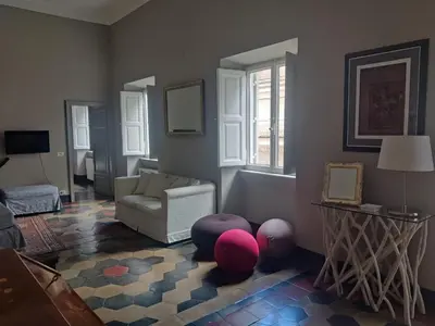 a living room with a couch and a chair at Warm Charming Apartment in Campo de Fiori in Rome