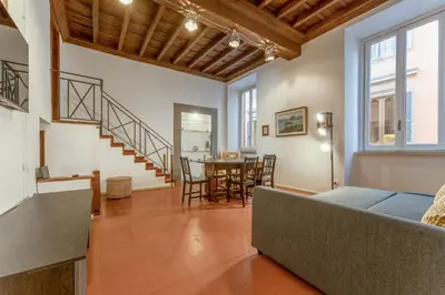 a living room with a couch and a table at Ciambella Arch Apartment for 6 people @Largo Argentina in Rome