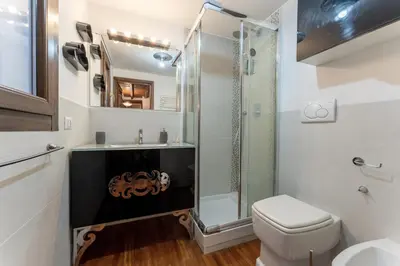 a bathroom with a shower and a toilet and a sink at Ciambella Arch Apartment for 6 people @Largo Argentina in Rome