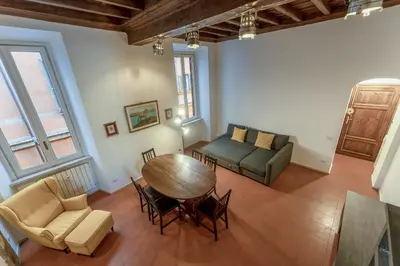 a living room with a table and a couch at Ciambella Arch Apartment for 6 people @Largo Argentina in Rome