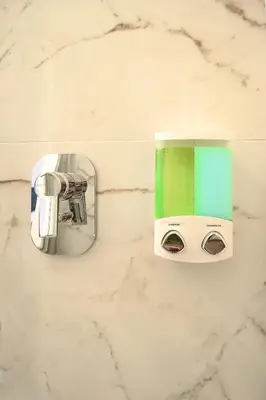 a green and white coffee maker on a wall at Lele Rooms Termini in Rome