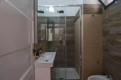 a bathroom with a shower and a sink and a toilet at [Roma Termini] - Suite elegante in Rome