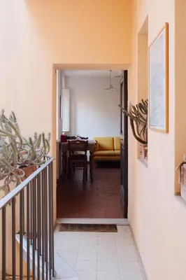 a hallway leading to a living room with a table at Quiet apartment in the heart of Trastevere in Rome