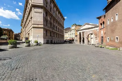 an empty street in an old city with buildings at Portico d'Ottavia LUX in Rome