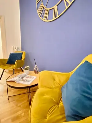 a living room with a yellow couch and a table at Dimora Centro Storico Roma in Rome