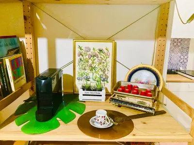 a shelf with a table with a toy house at La Casetta di San Giovanni 1924 in Rome
