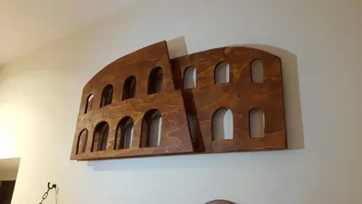 a sculpture of a building on a wall at The Rabbit Hole in Rome