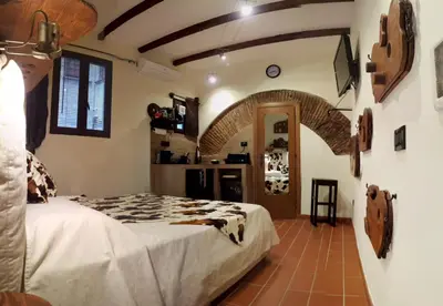 a bedroom with a bed in a room with a brick floor at The Rabbit Hole in Rome