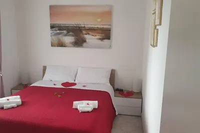 a bedroom with a red bed with two hearts on it at Delizioso appartamento San Pietro in Rome