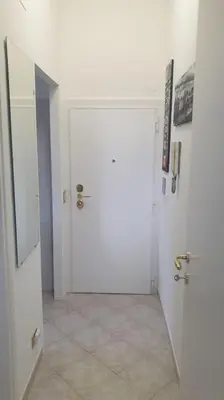 a room with two white doors and a tile floor at Delizioso appartamento San Pietro in Rome
