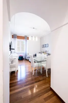 a dining room and living room with a table and chairs at Appio11 Apartment in Rome