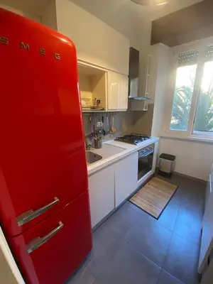 a kitchen with a red refrigerator and a sink at Appio11 Apartment in Rome